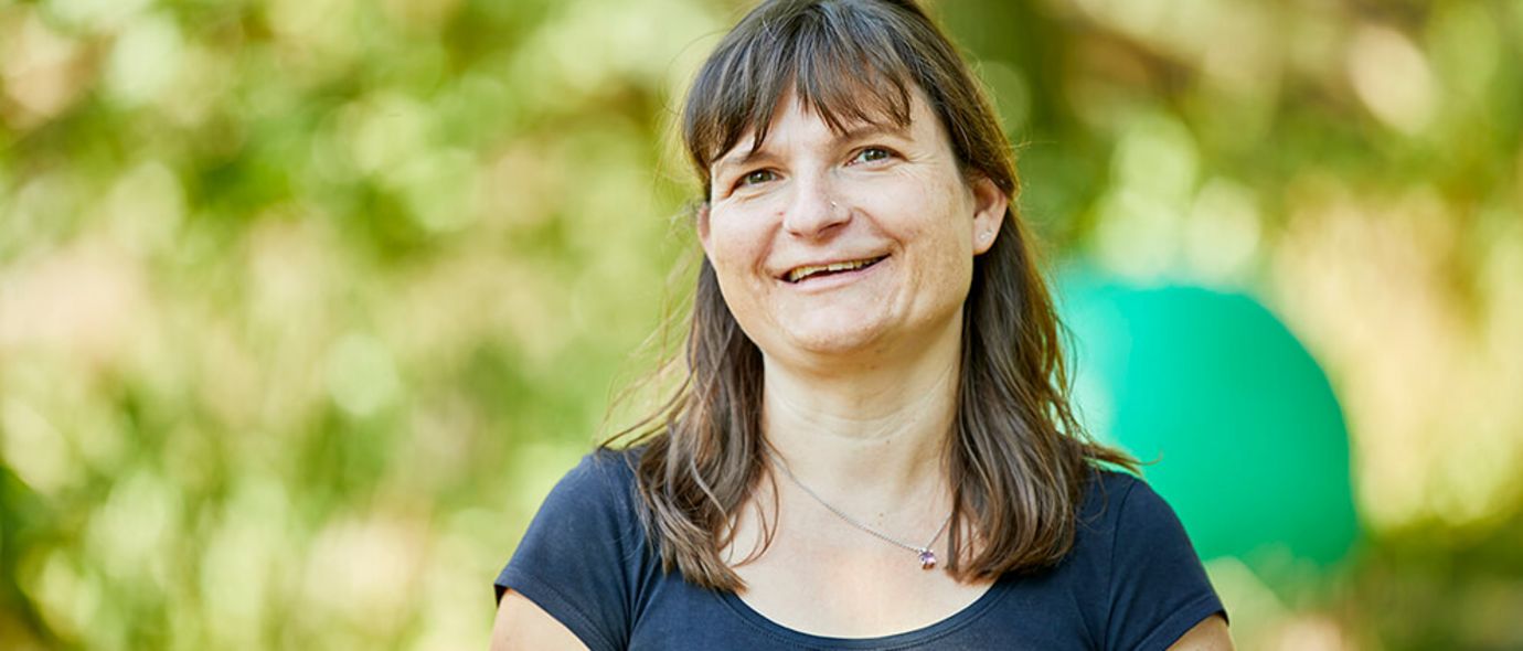 Patientin spaziert beim Waldbaden durch den Wald